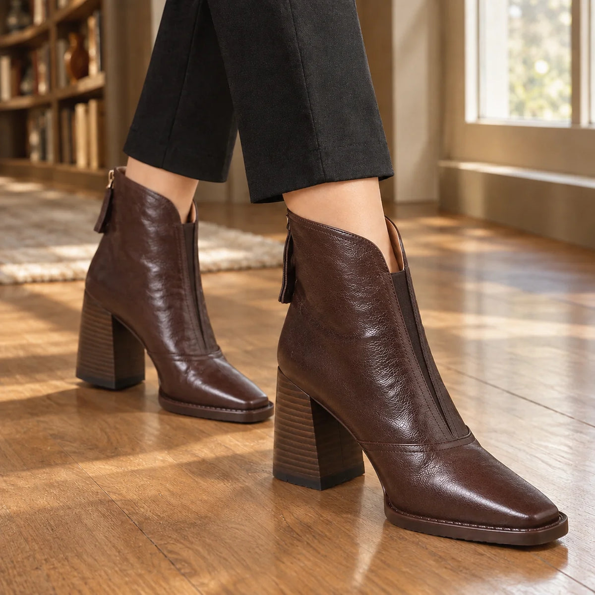 Women's black ankle boots, close-up of high block heel