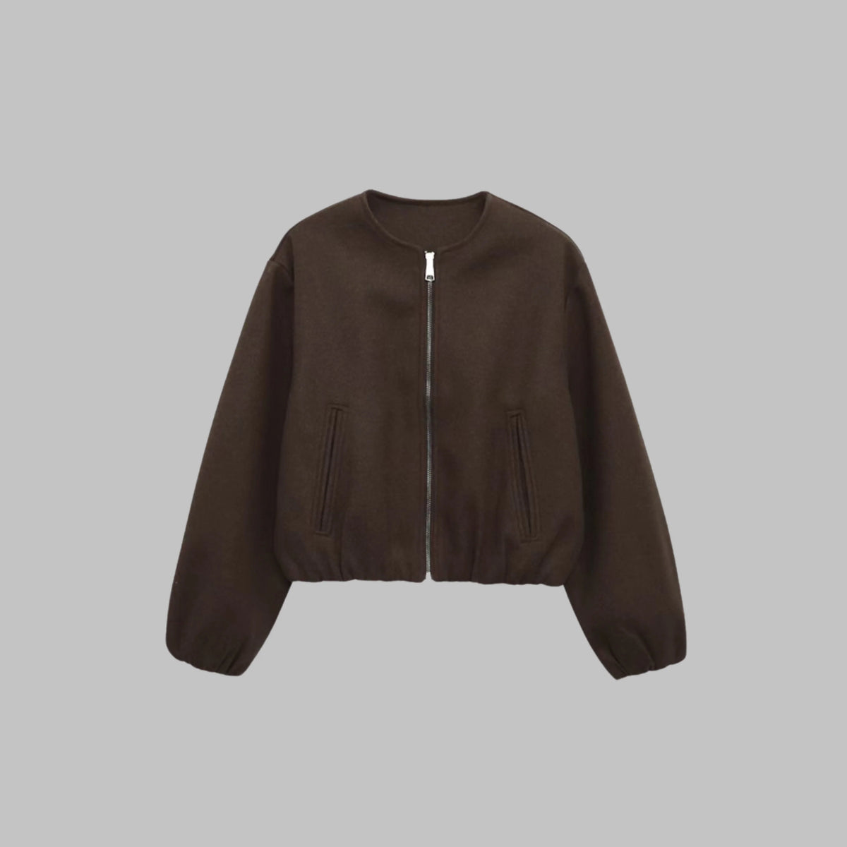 Women's brown cropped jacket, close-up of zip