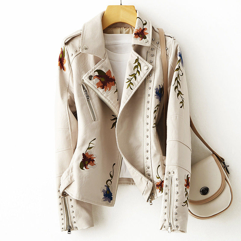 Women's white faux leather moto jacket with floral embroidery and stud detail