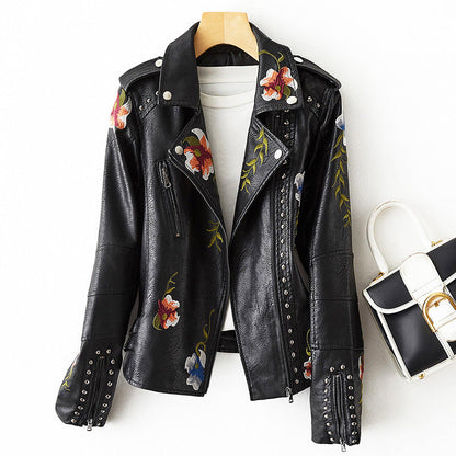 Women's white faux leather moto jacket with floral embroidery and stud detail