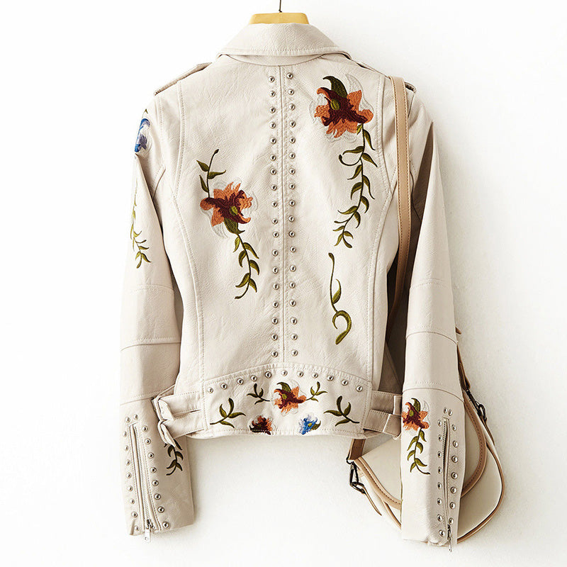 Women's white faux leather moto jacket with floral embroidery and stud detail