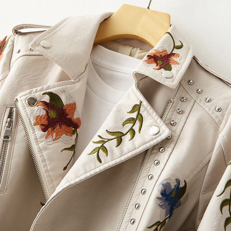 Women's white faux leather moto jacket with floral embroidery and stud detail