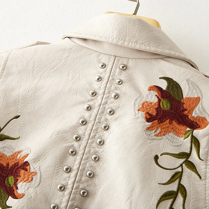 Women's white faux leather moto jacket with floral embroidery and stud detail