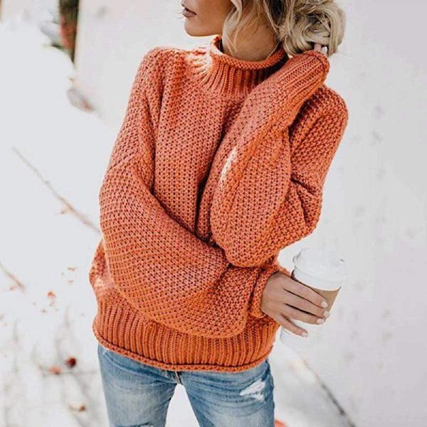 Women's orange turtleneck sweater with relaxed knit design