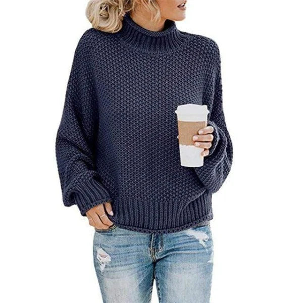 Women's navy blue turtleneck sweater with relaxed knit design