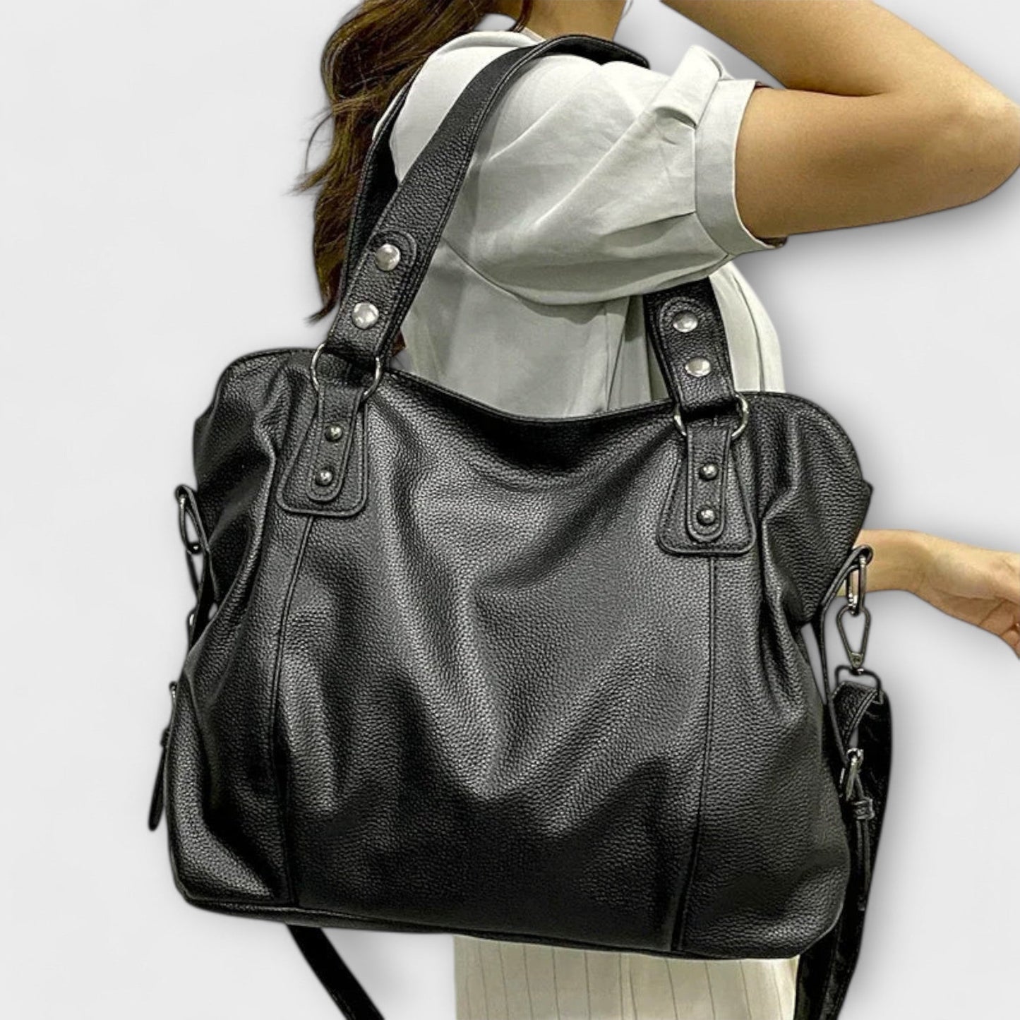 Women's black vegan leather shoulder bag with crossbody strap