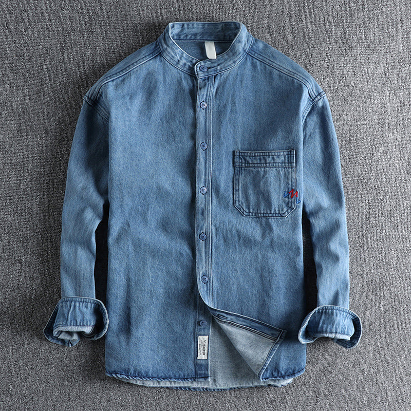 Men's light blue washed denim shirt with chest pockets and long sleeves