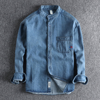 Men's light blue washed denim shirt with chest pockets and long sleeves