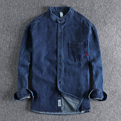 Men's light blue washed denim shirt with chest pockets and long sleeves