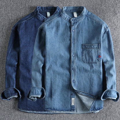 Men's light blue washed denim shirt with chest pockets and long sleeves