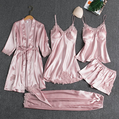 Women's pink satin pajama set with lace trim and robe