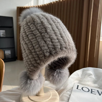 Women's gray plush winter hat with pom poms