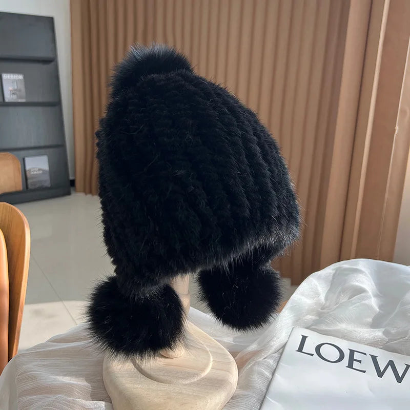 Women's black plush winter hat with pom poms