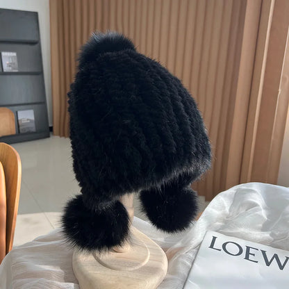 Women's black plush winter hat with pom poms