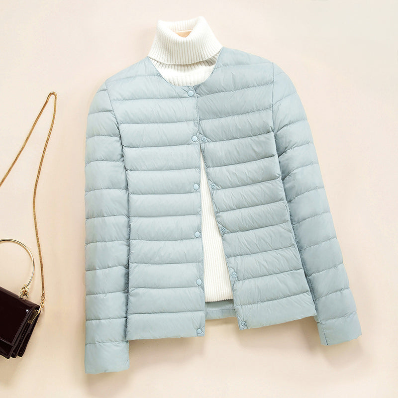 Women's blue lightweight quilted down jacket with round neck and snap front