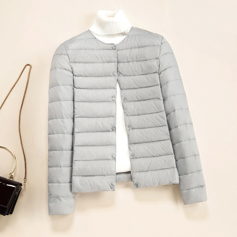 Women's blue lightweight quilted down jacket with round neck and snap front