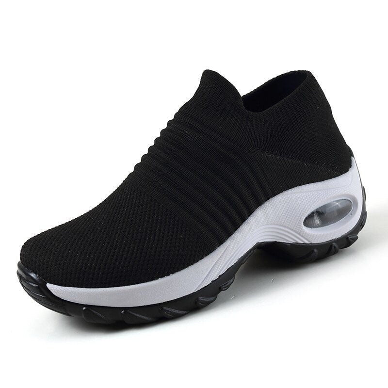 Women's black slip-on walking sneakers with grey air cushion sole