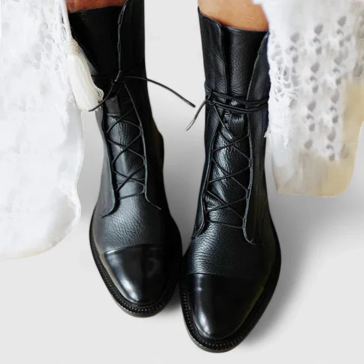 Women's cushioned leather lace-up cap-toe combat boots in black
