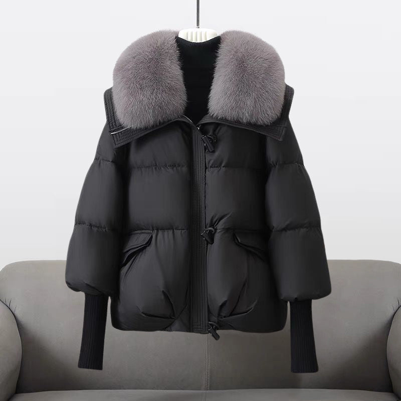 Women's black longline puffer jacket with faux fur collar