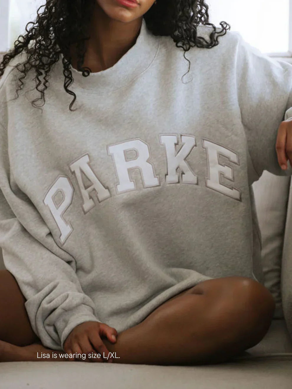 Gray oversized varsity sweatshirt with white lettering