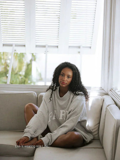 Gray oversized varsity sweatshirt with white lettering