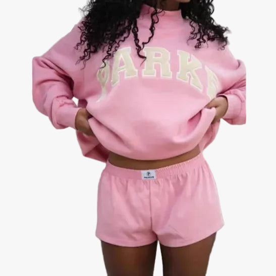 Women's pink mock neck sweatshirt with varsity lettering