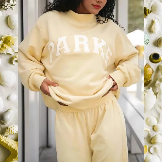 Women's pink mock neck sweatshirt with varsity lettering