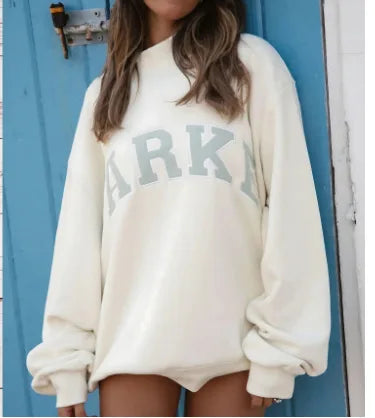 Women's pink mock neck sweatshirt with varsity lettering