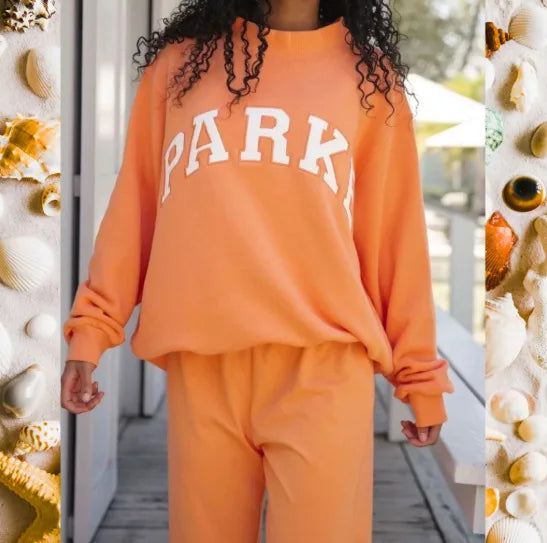 Women's pink mock neck sweatshirt with varsity lettering