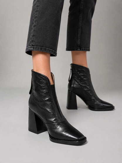 Women's black ankle boots, close-up of block heel